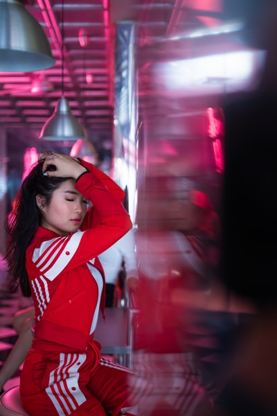 They wore red uniforms woman sitting on a chair in the building
